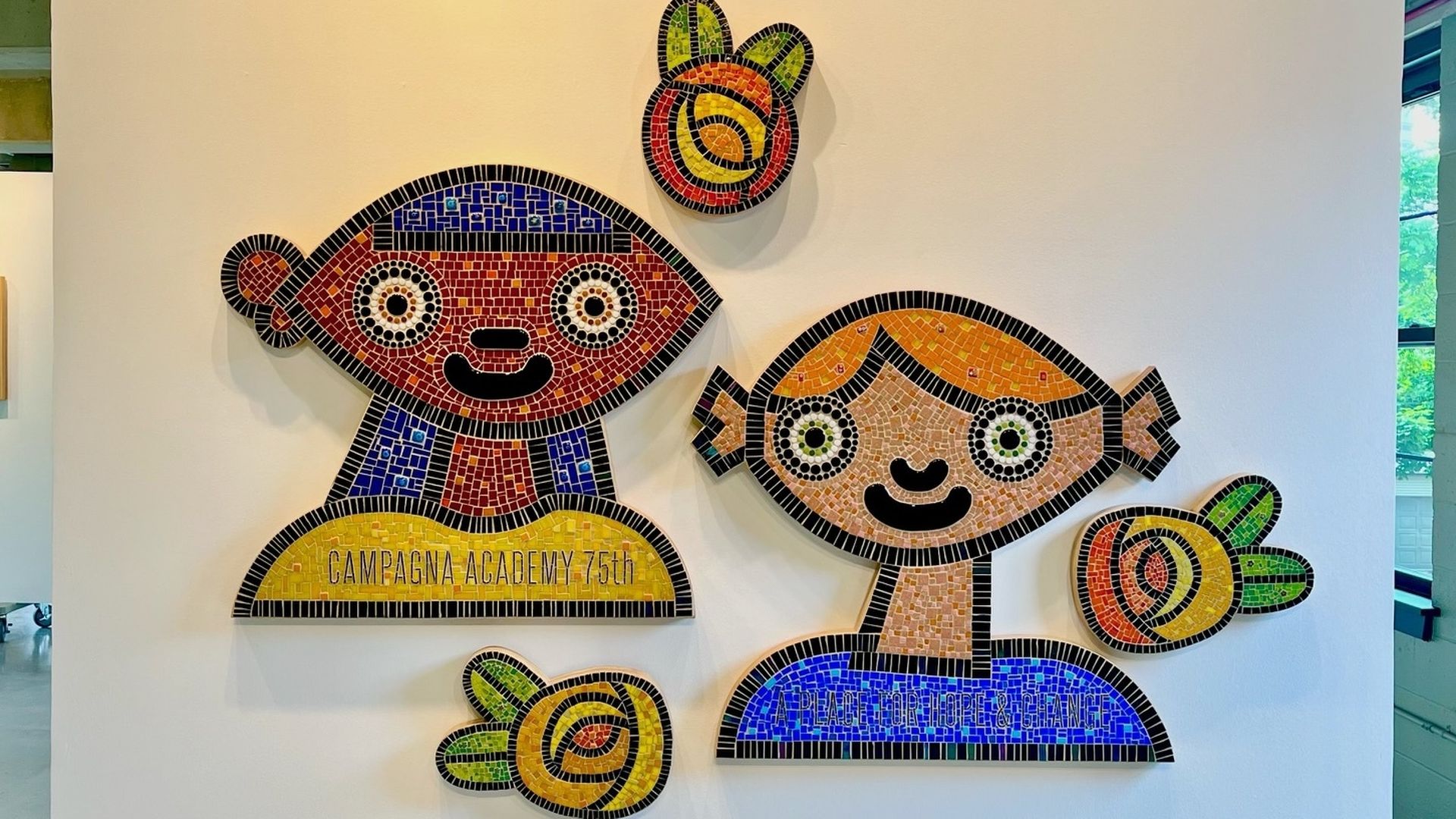 Photo of a painting of two people and three flowers 