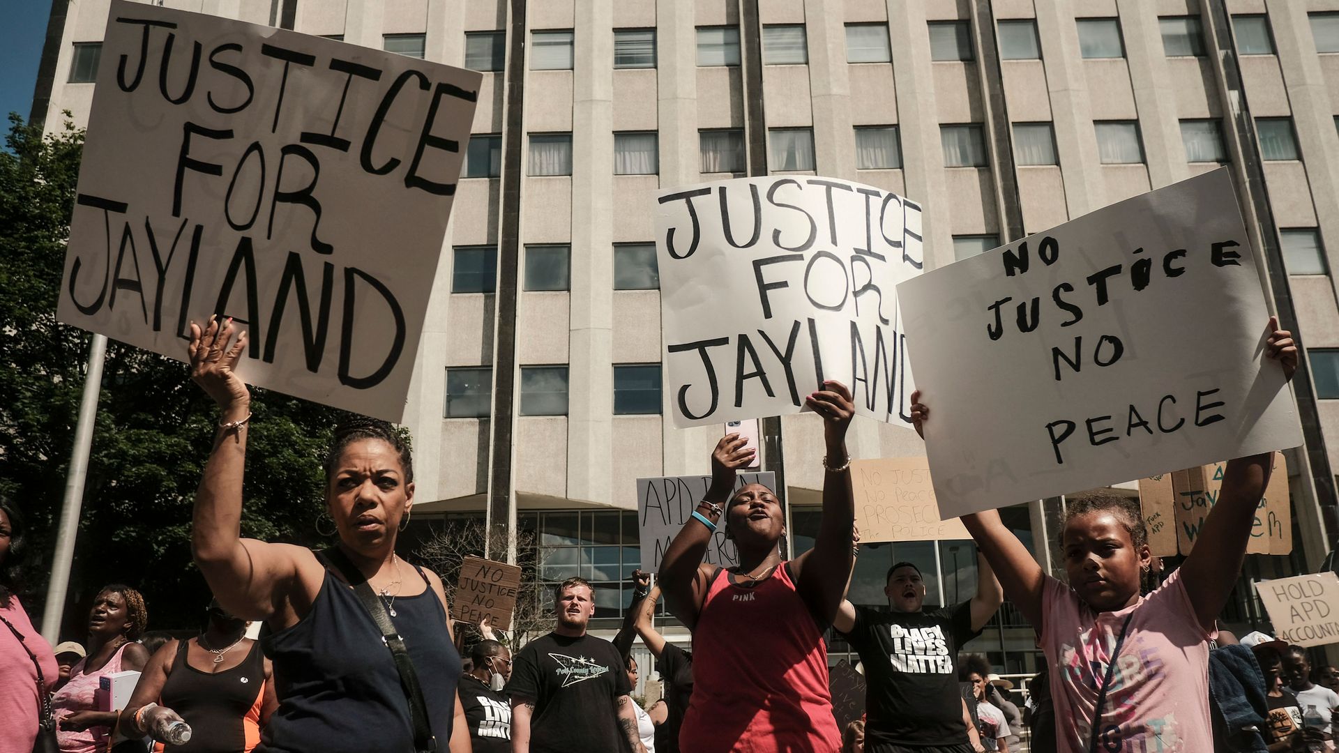 Protestors hold signs reading "Justice for Jayland" in Akron.