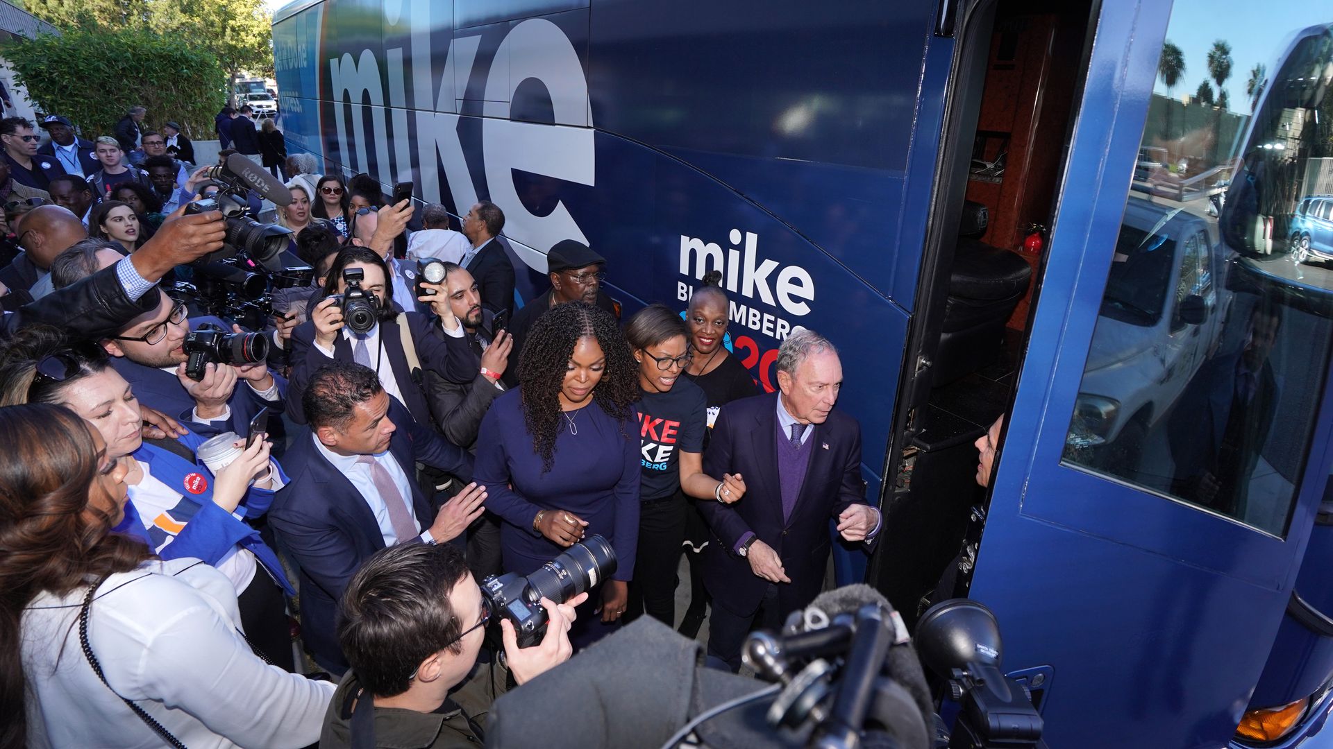 Michael Bloomberg outside his campaign bus in Compton, California