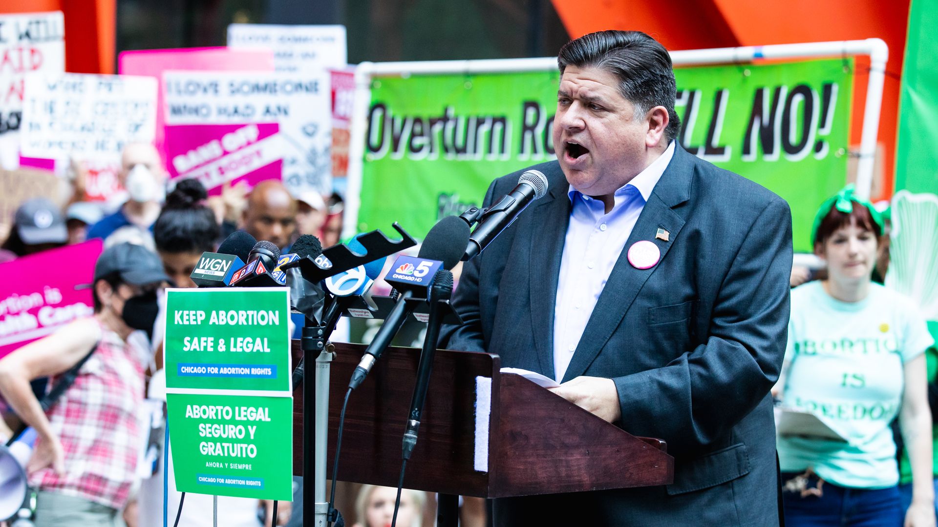 Politician in front of signs