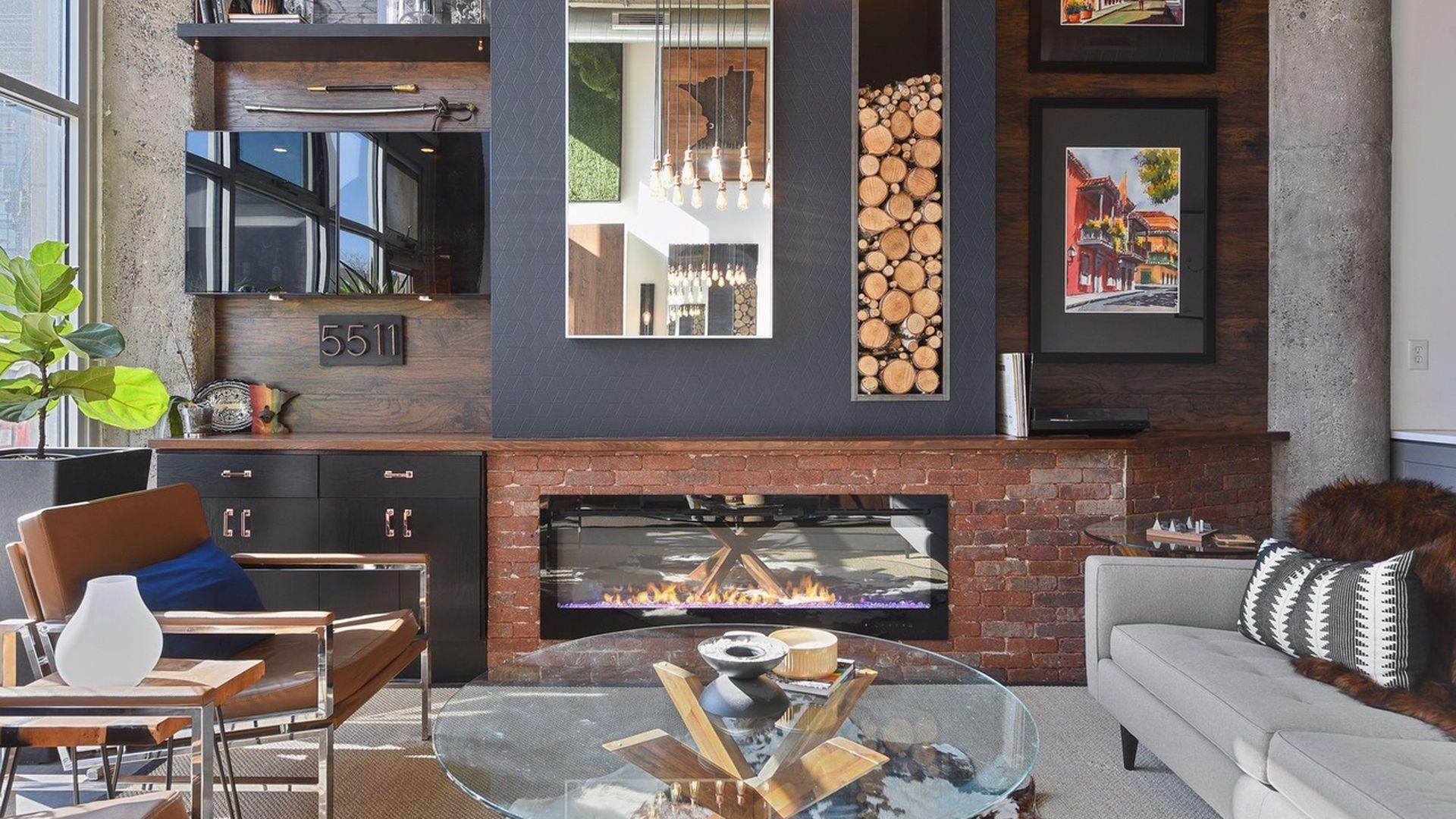living room with brick fireplace and wood paneling