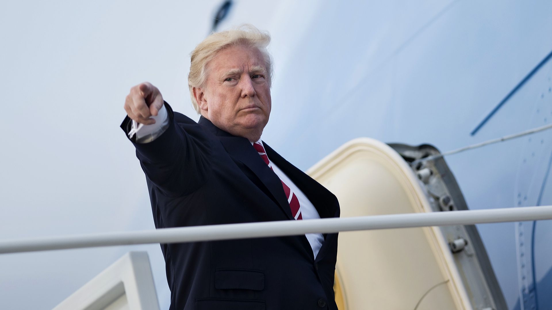 Trump points as he boards AF1