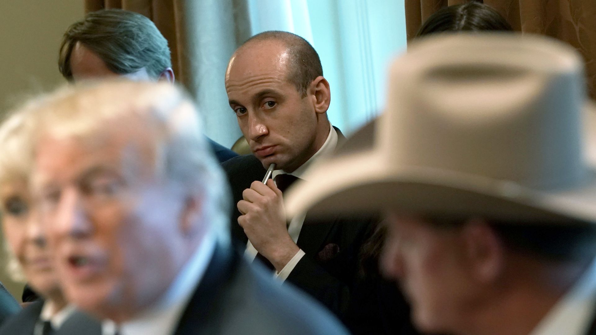 Stephen Miller is showing looking toward Donald Trump.