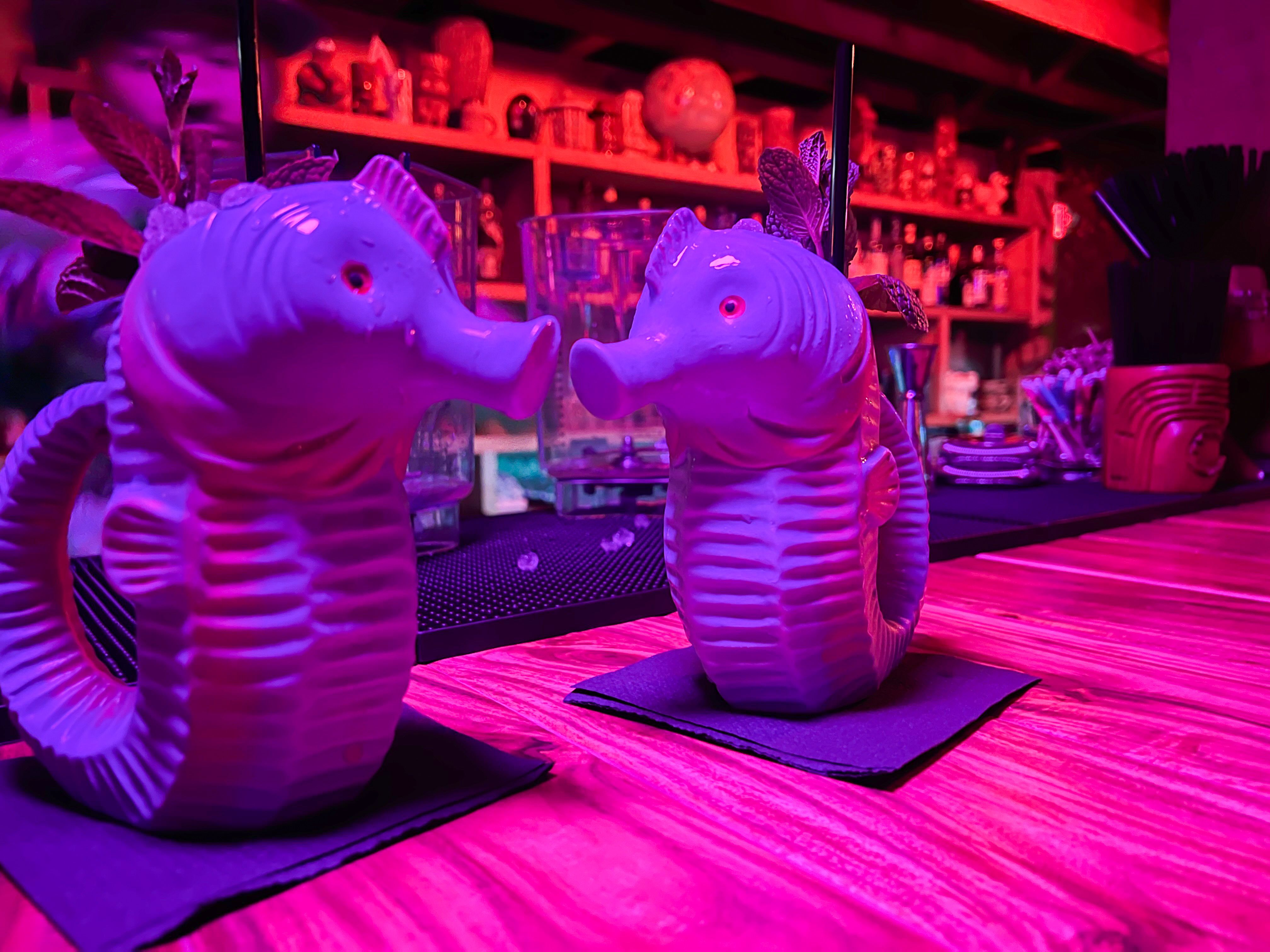 Two seahorse-shaped cocktail glasses.