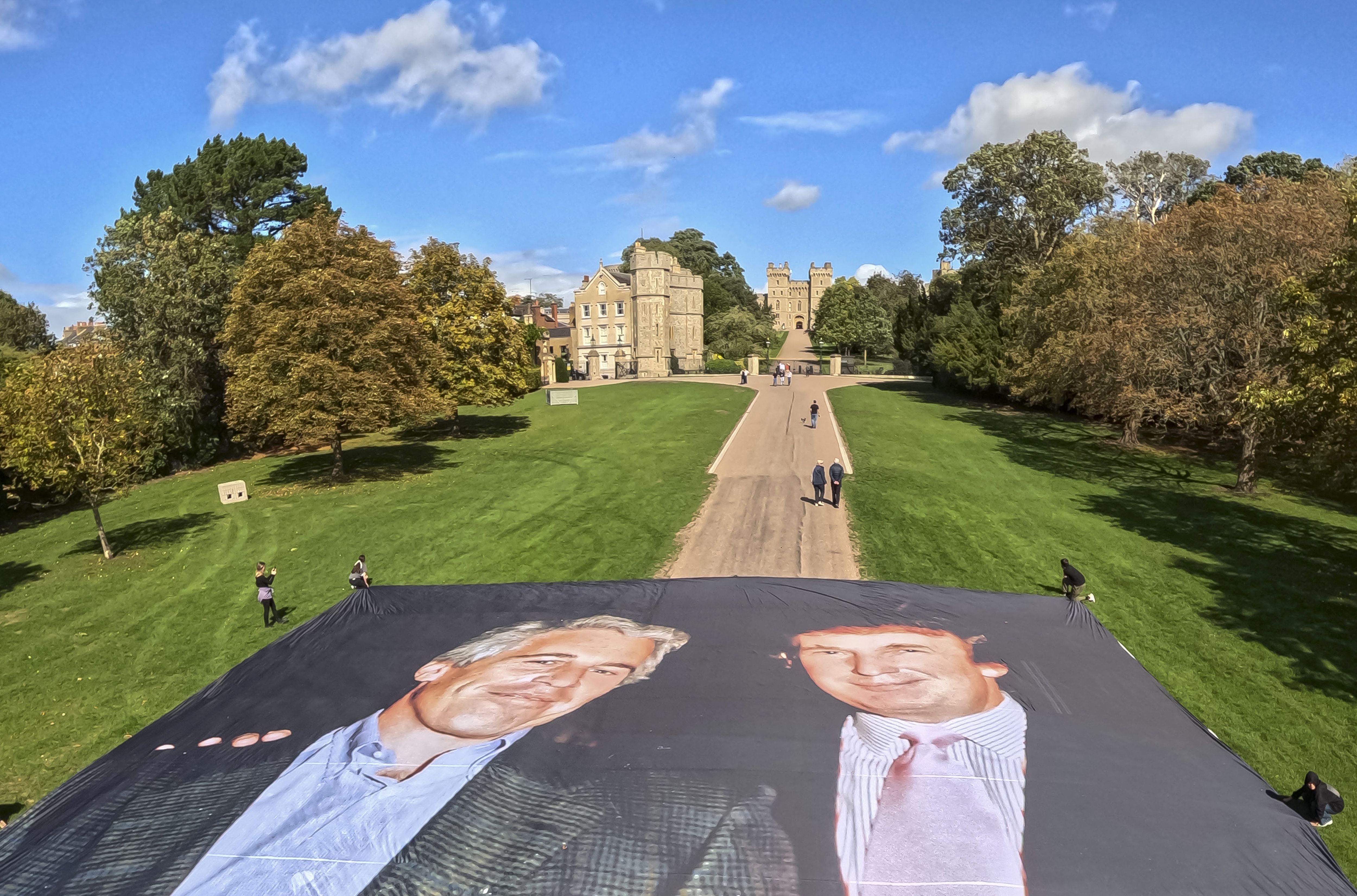Photos: Activists beam Trump, Epstein images onto U.K. castle during president's visit