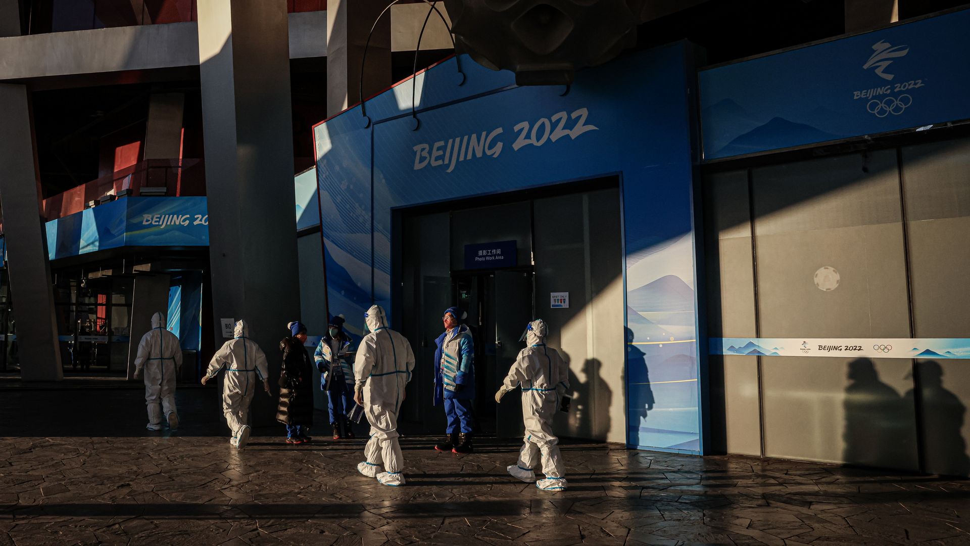 Venue staff decked in personal protective equipment walk in the compound of the National Stadium on February 04, 2022 in Beijing, China.