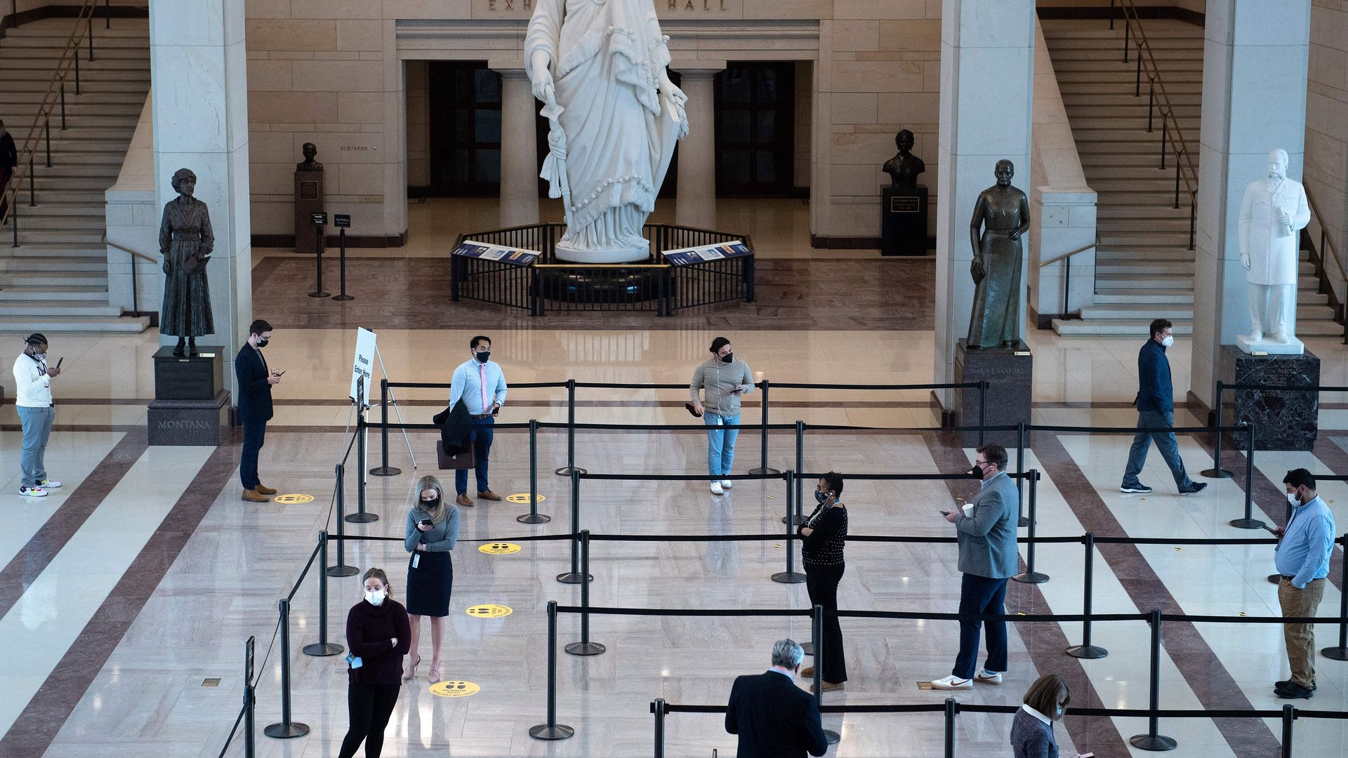 Congressional staffers and others are seen lined up in the Capitol Visitors Center as they await coronavirus tests.