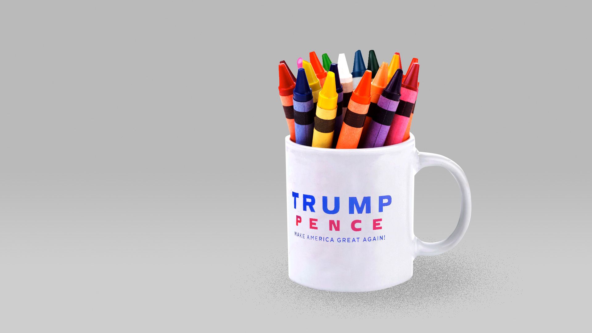 A coffee mug with the Trump/Pence logo holding crayons