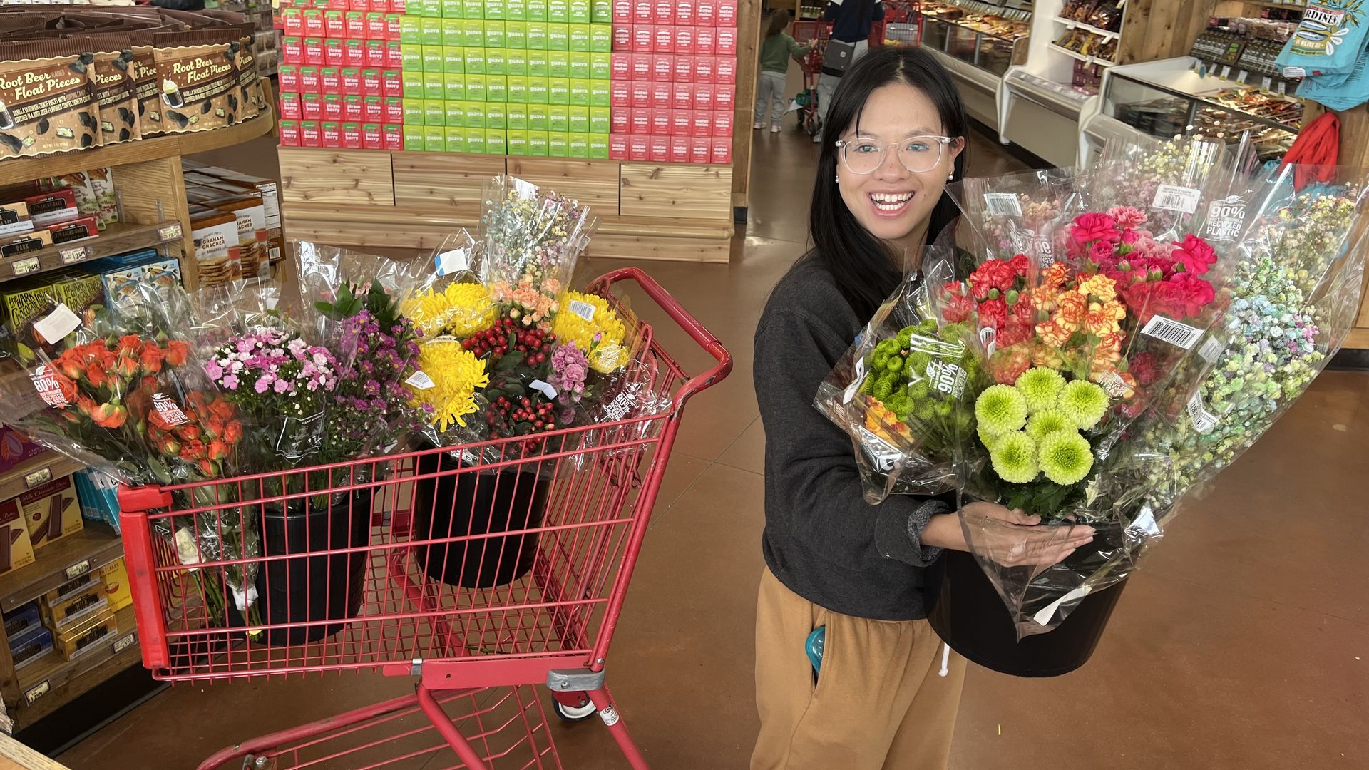 Linh holding flowers at trader joe's