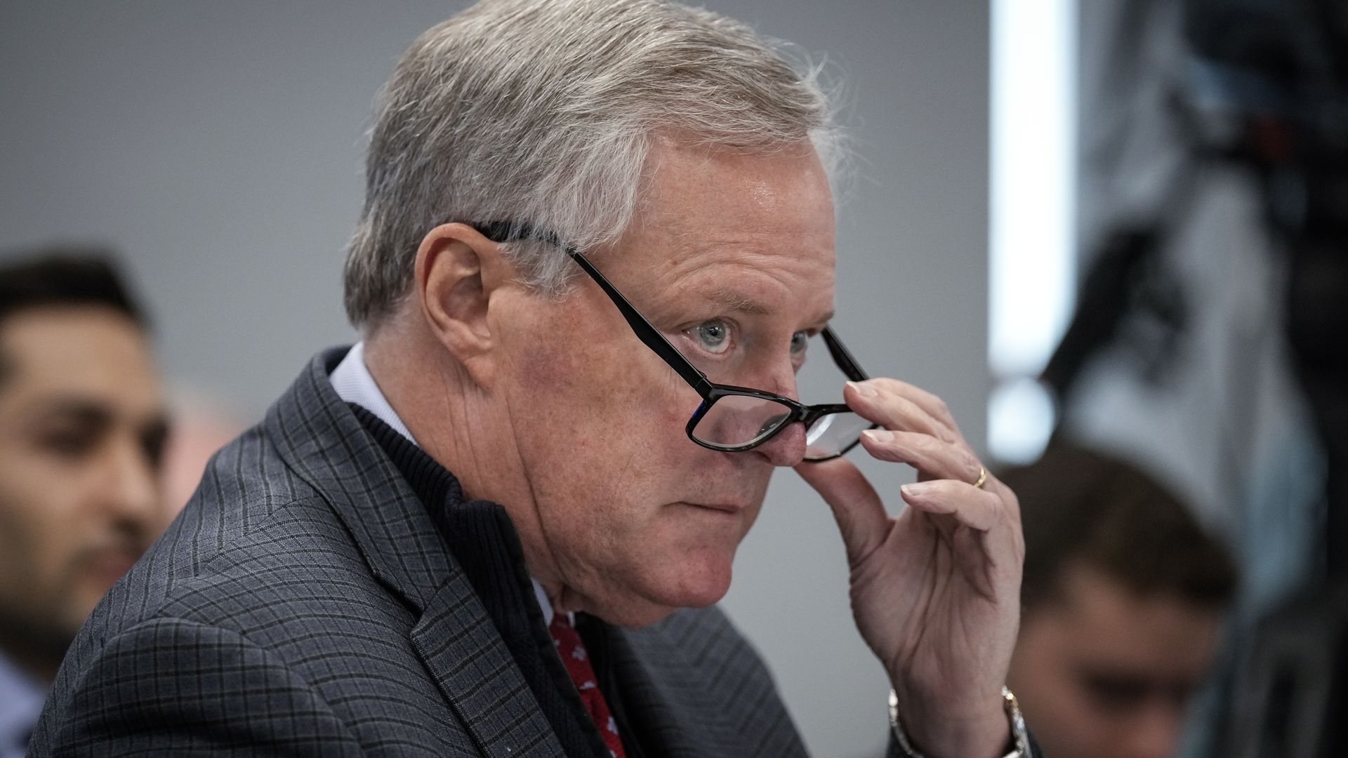 Photo of Mark Meadows holding his glasses