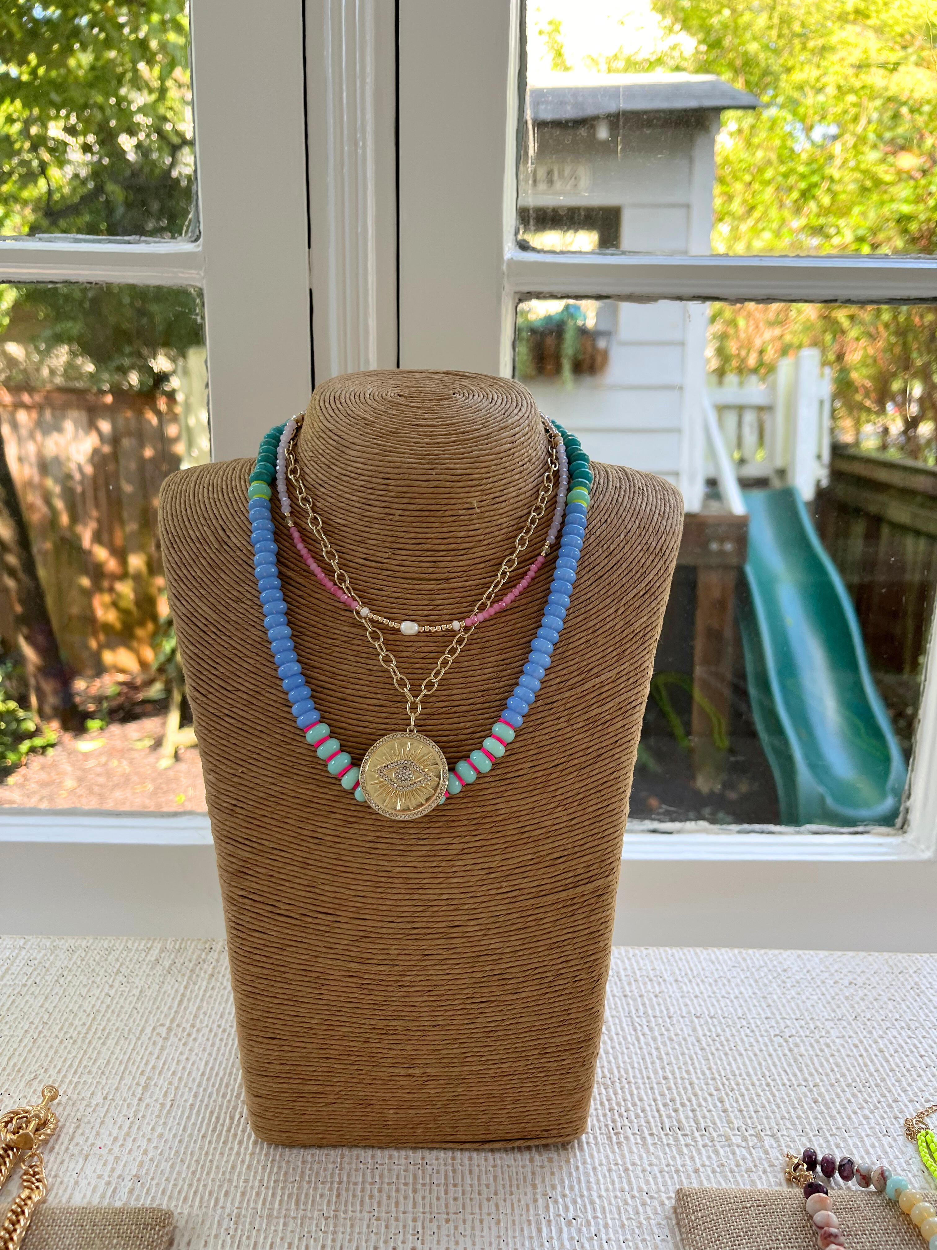 multiple necklaces layered on display