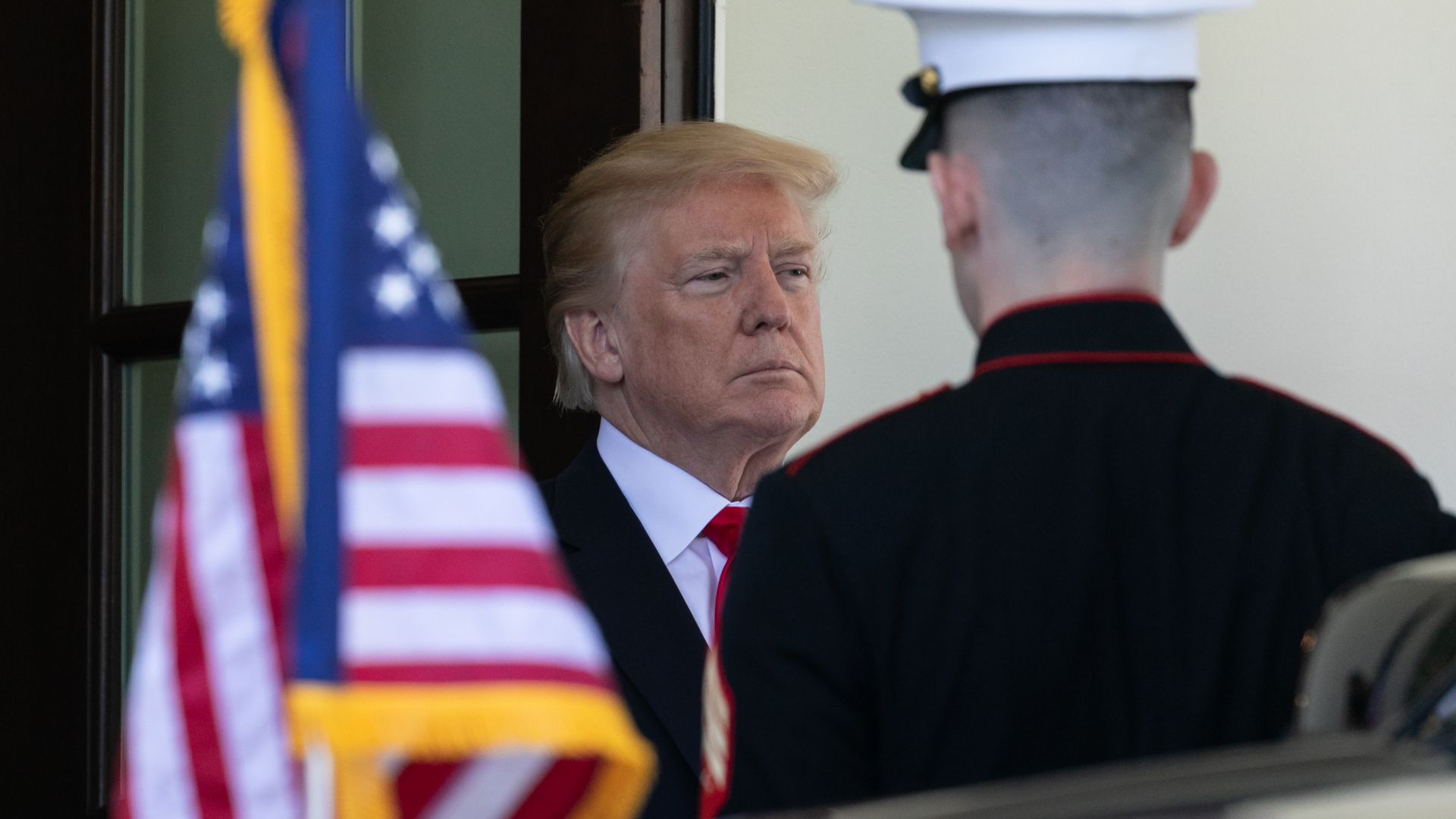 President Trump near an American flag.