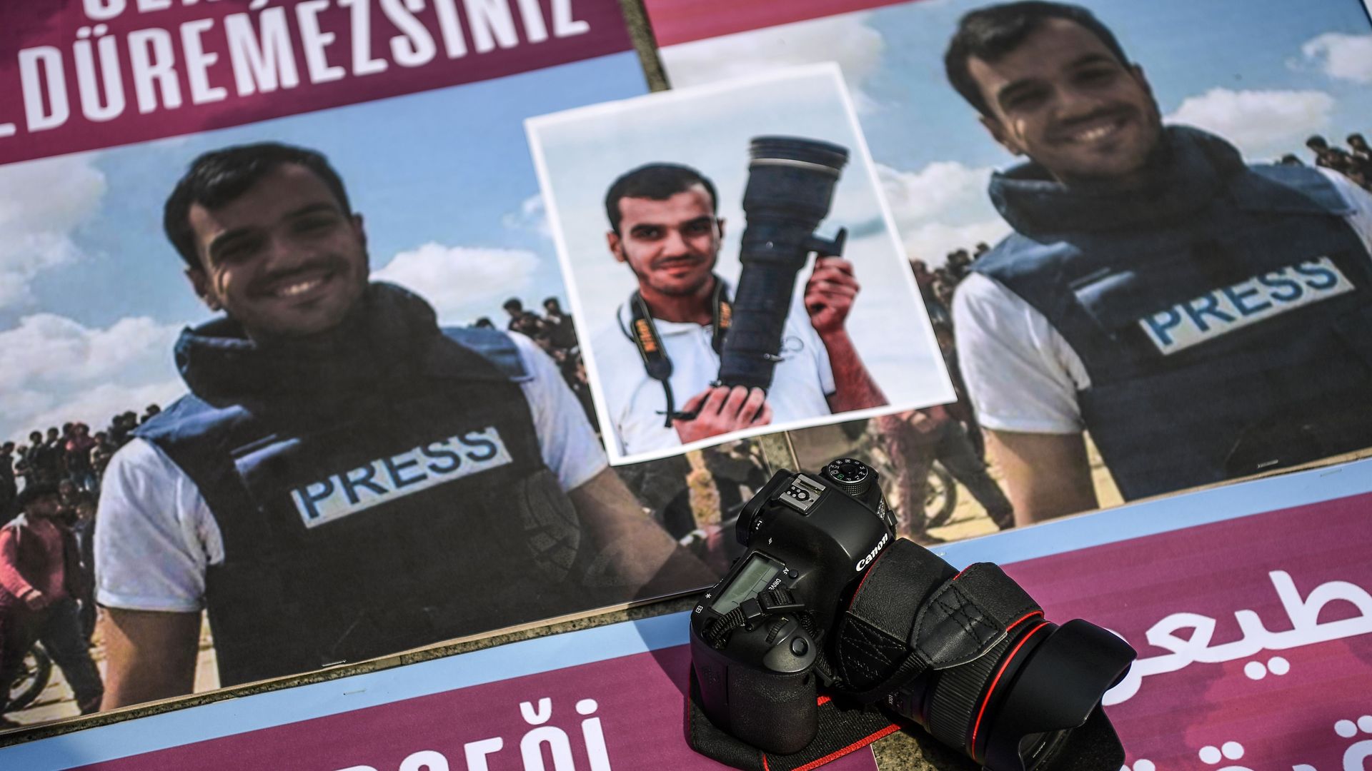 People take part in a protest against the killing of a fellow journalist Palestinian Yasser Murtaja
