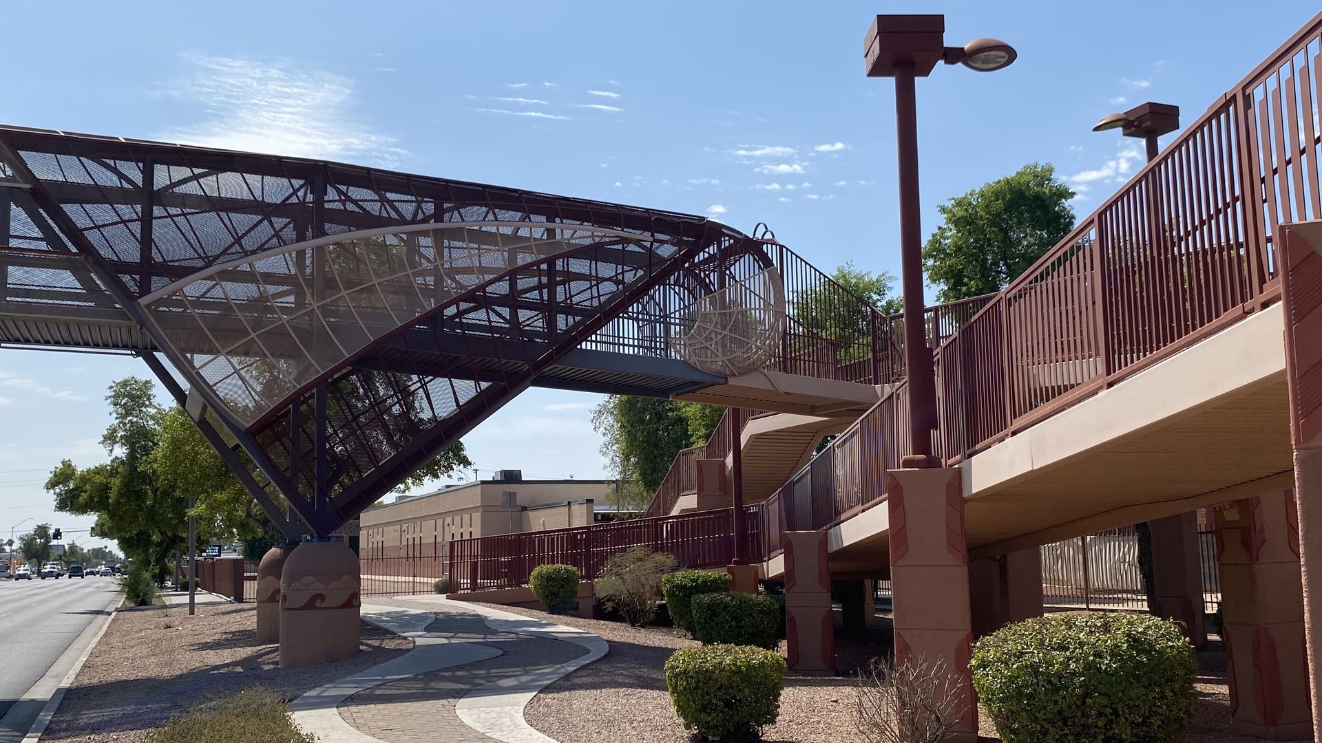 One end of a pedestrian overpass above a street. 