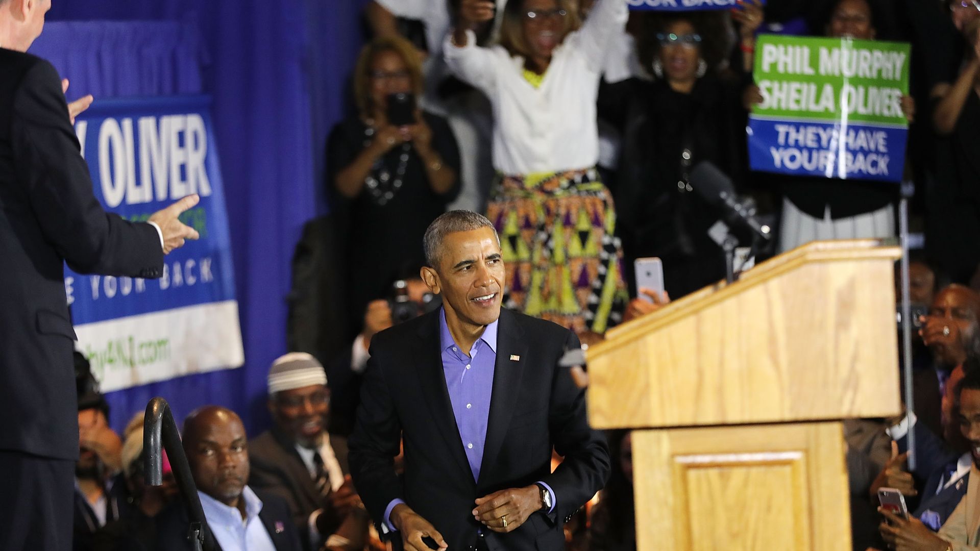 Barack Obama running up the stairs at a campaign rally