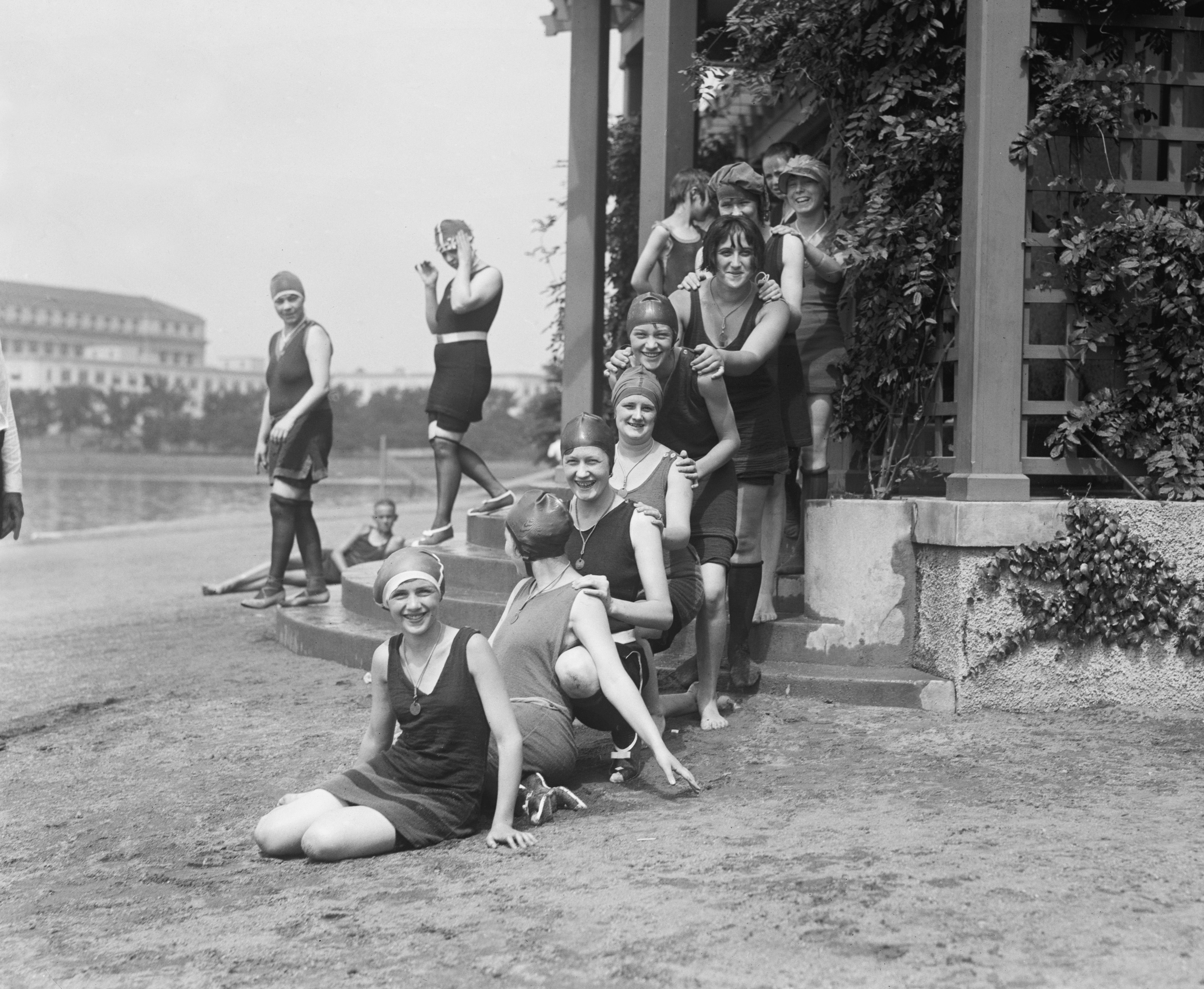 A group of women in bathing suits and swim caps at the bathing beach at the Tidal Basin in D.C. in the early 20th century.