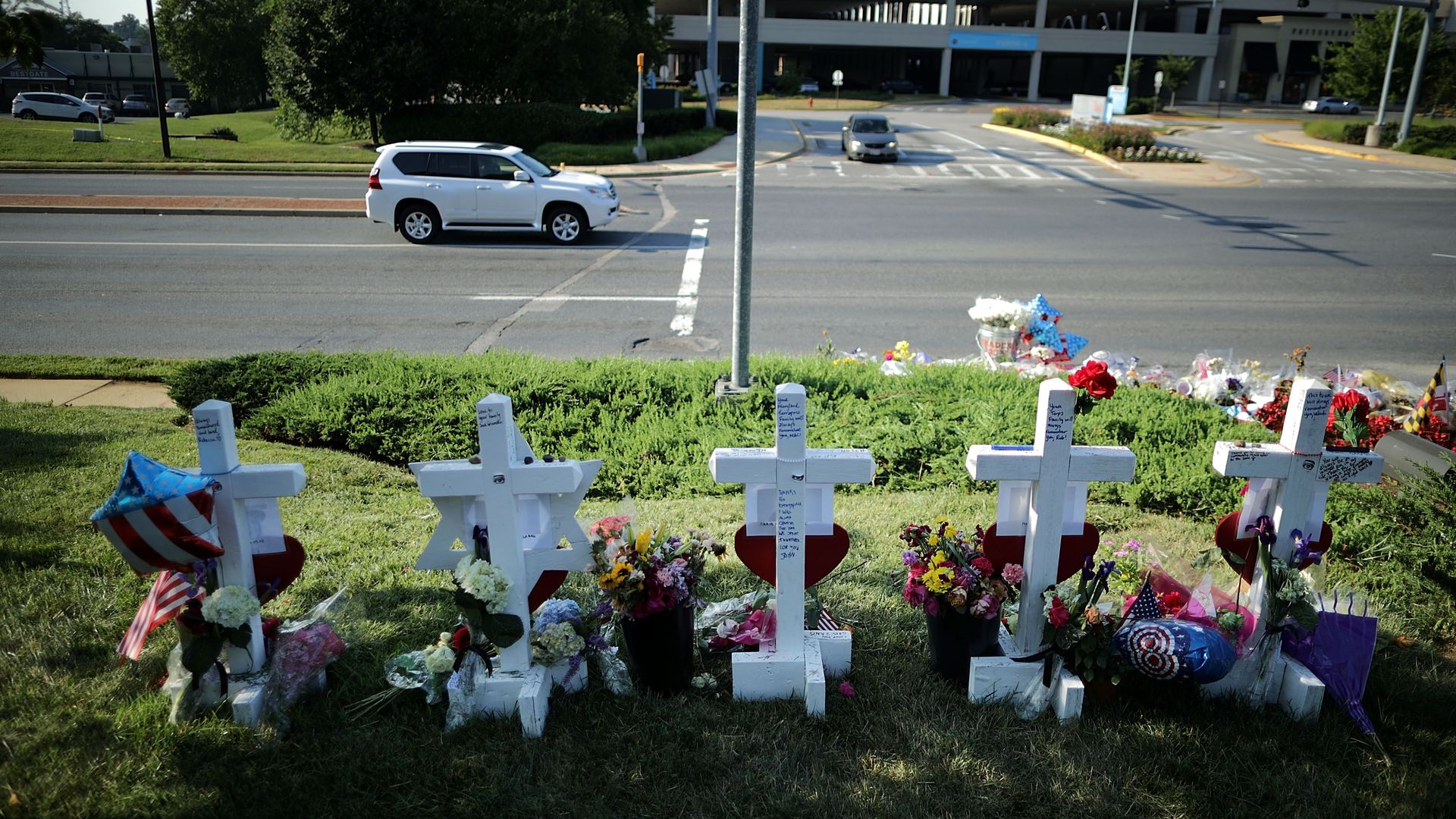 Five wood markers stand in a makeshift memorial outside the Annapolis Capitol Gazette offices for the employees killed by a gunman last week July 2, 2018