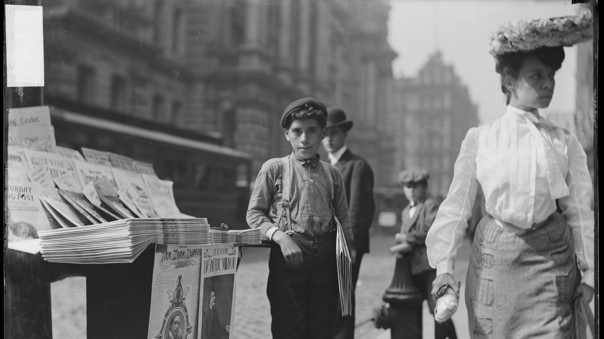 Photo of a boy selling newspapers decades ago 