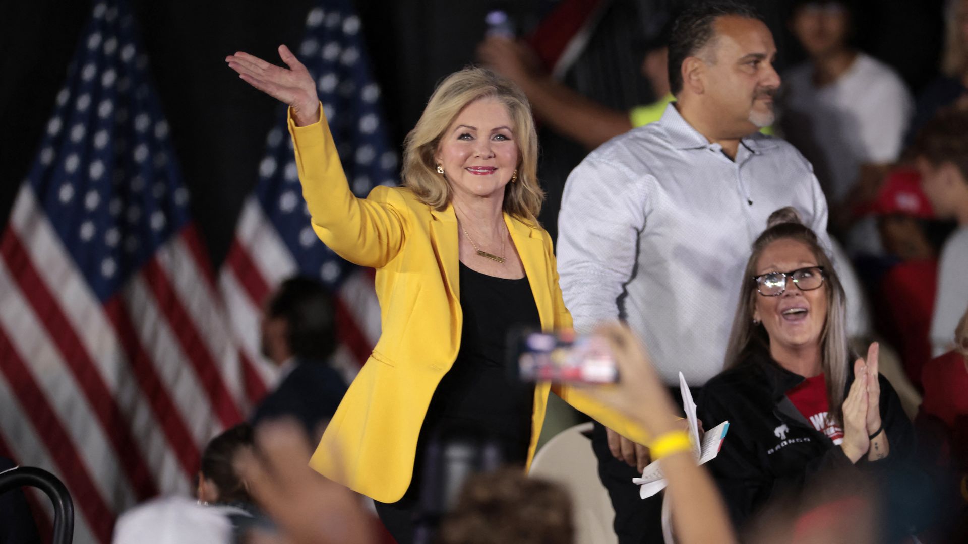 Sen. Marsha Blackburn (R-TN) waves as she arrives for a town hall with former US President and Republican presidential candidate Donald Trump 