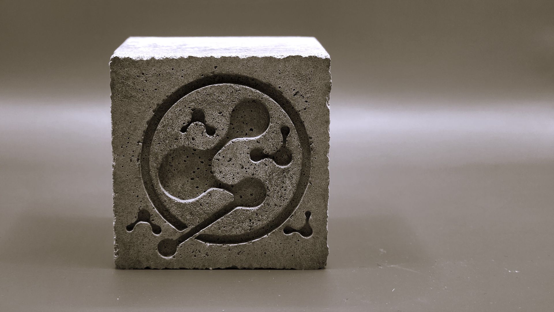 A cube of low carbon cement made with Queens Carbon's technology