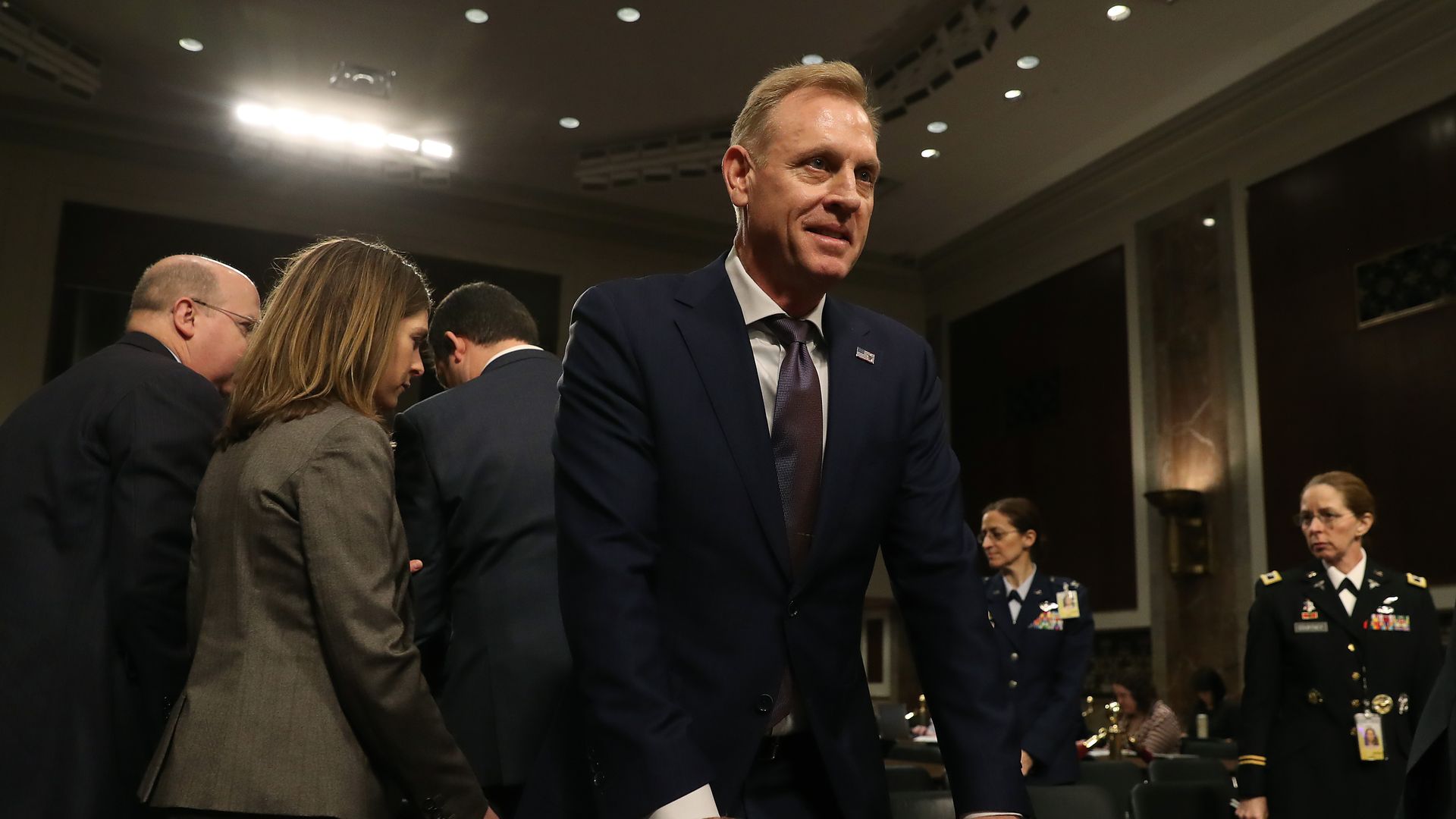Acting Defense Secretary Patrick Shanahan stands behind the witness table at a congressional hearing