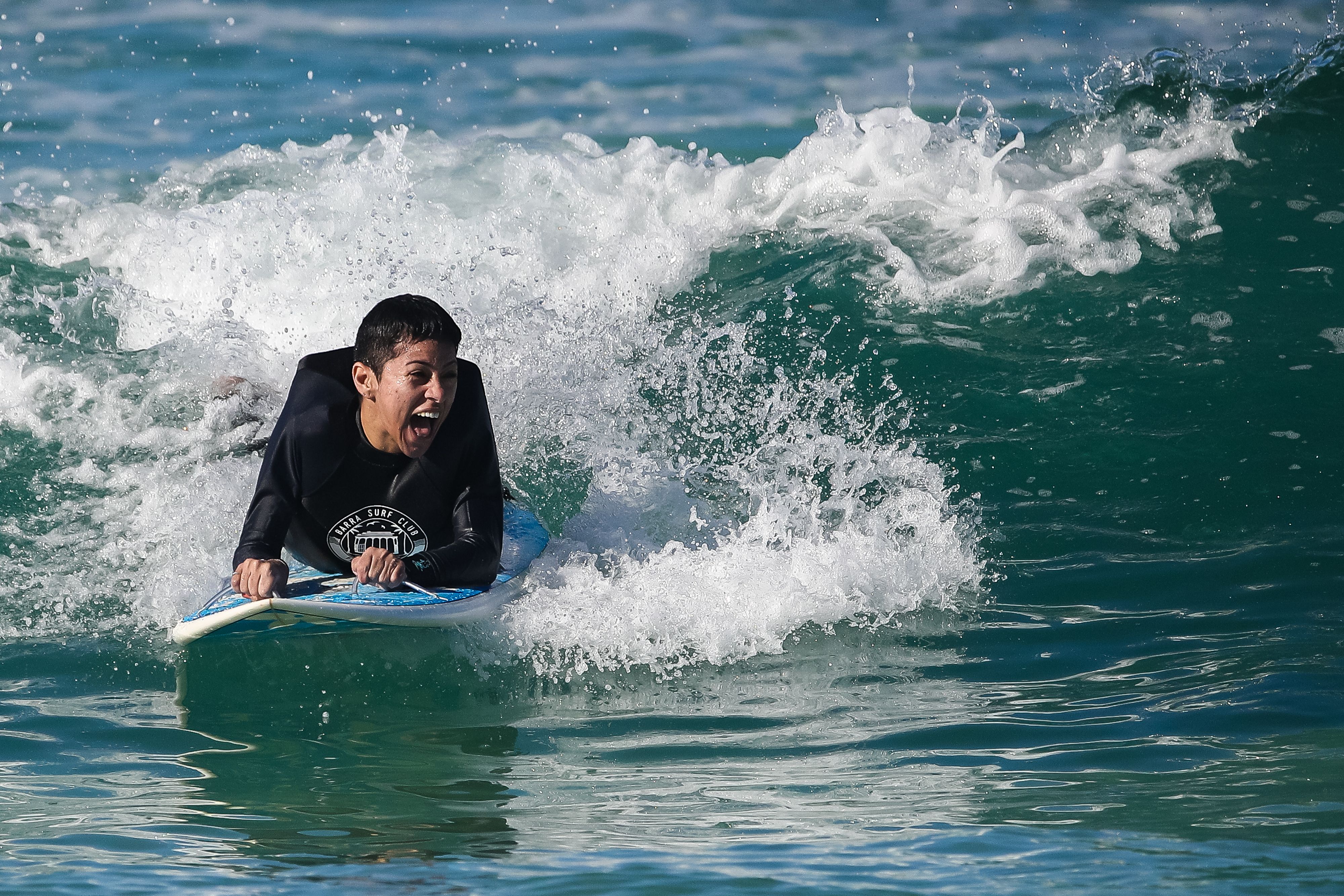 Adapted surfer rides a wave