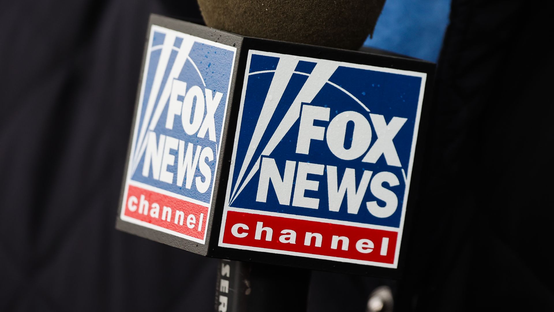 a close up photo of a FOX News microphone