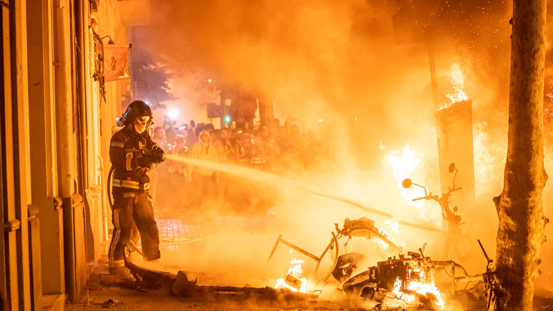 Barcelona firefighters put out fires during protests on October 16, 2019 in Barcelona