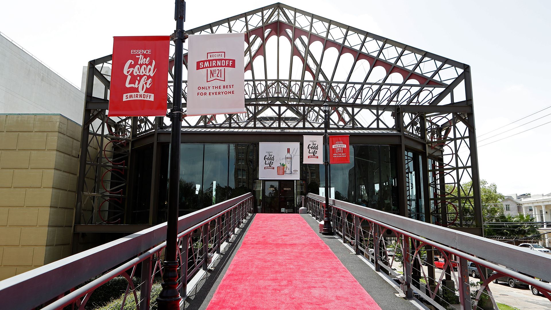 A walkway is covered with red carpet. It leads to a building designed like the Eiffel Tower.