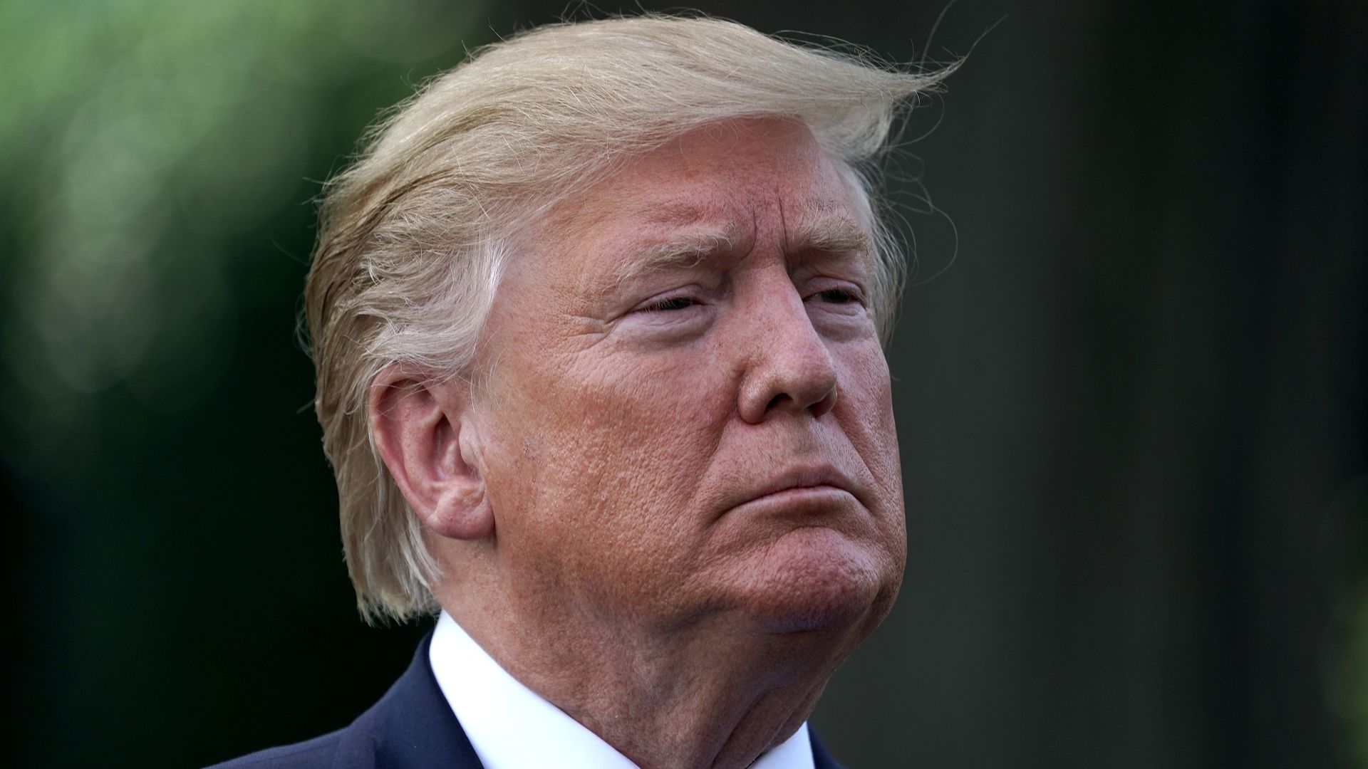 President Donald Trump talks to journalists before boarding Marine One and departing the White House August 02