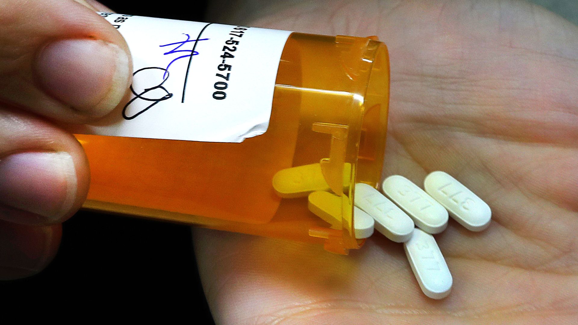 A pharmacist in Boston emptying a prescription bottle of opioid painkillers in September 2018.