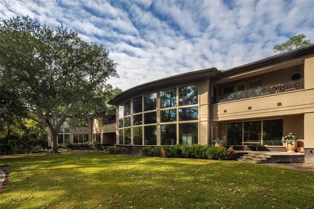 Photo of a house with glass windows as walls. 