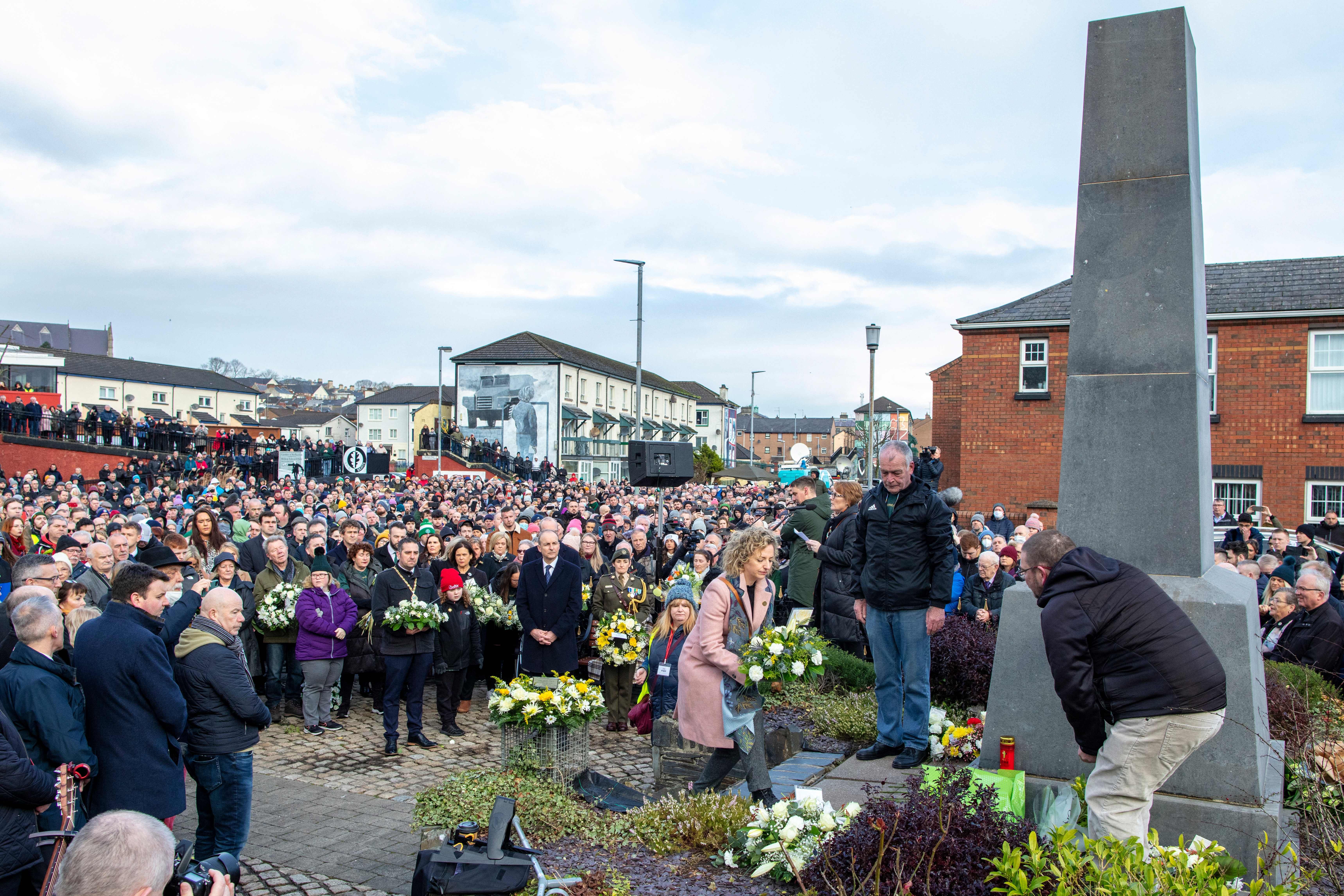 A member of a victim's family lays a wreath at a monument to those killed on Bloody Sunday