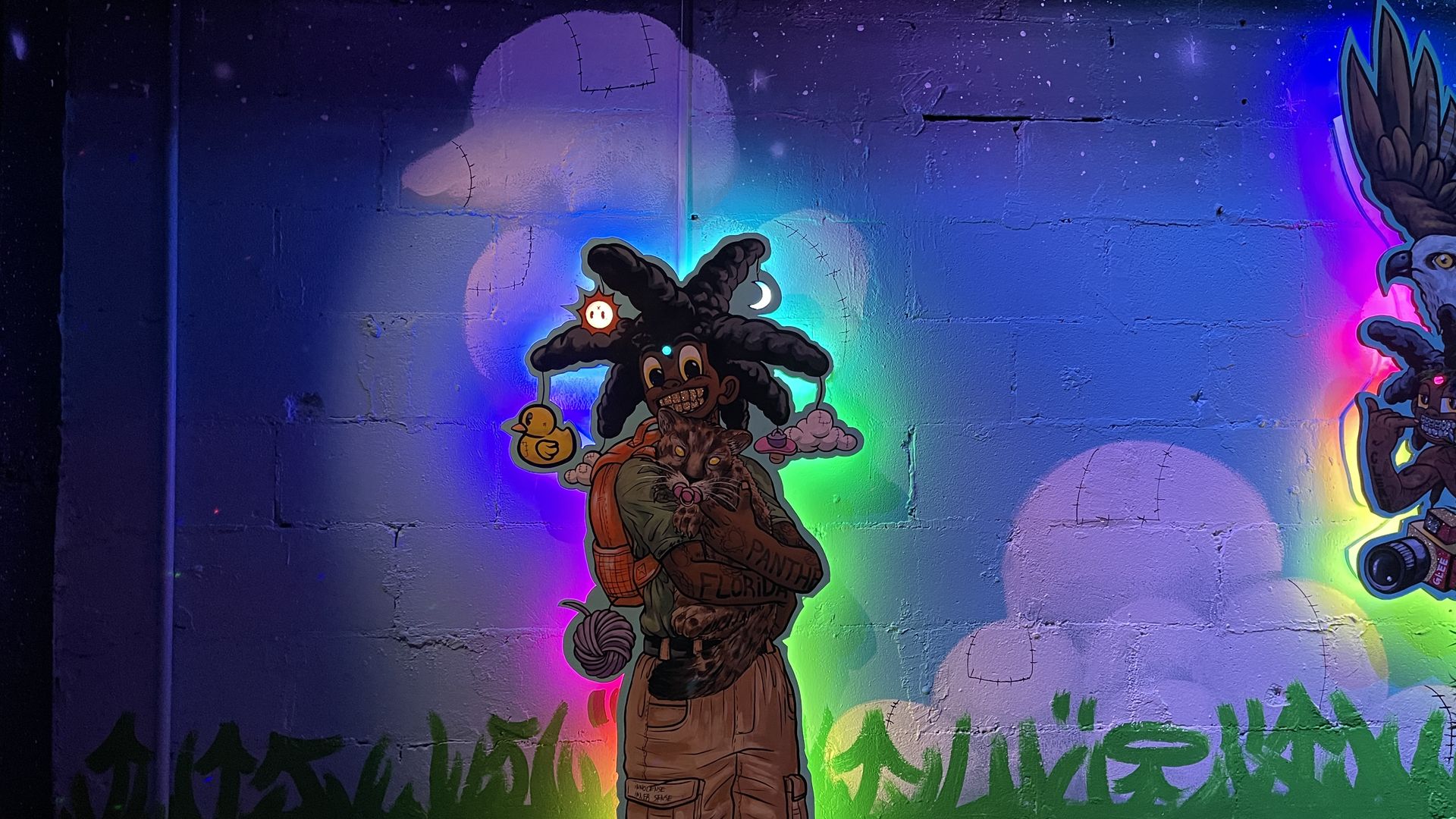 cutout artwork with glowing lights and clouds painted to look like ducks