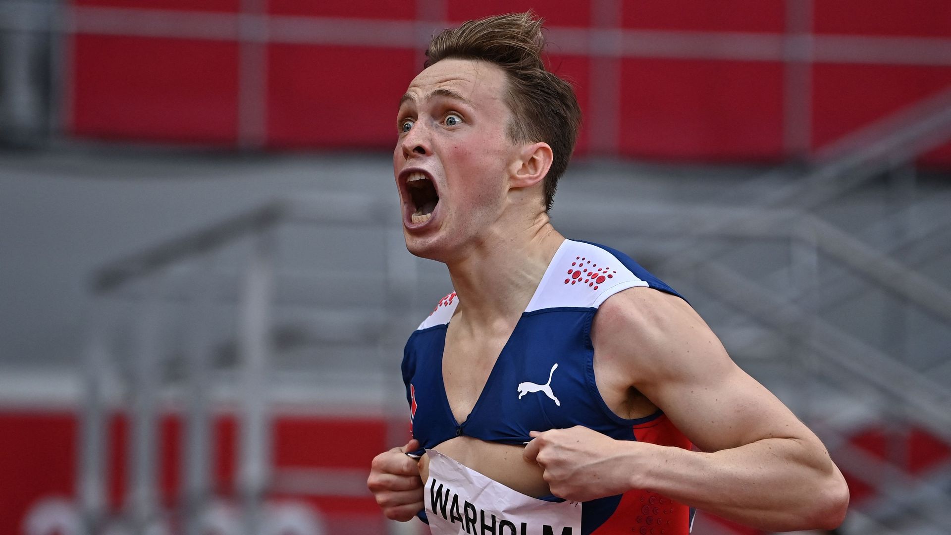 Norway's Karsten Warholm celebrates as he crosses the finish line to win the men's 400m hurdles final during the Tokyo 2020 Olympic Games at the Olympic Stadium in Tokyo on August 3
