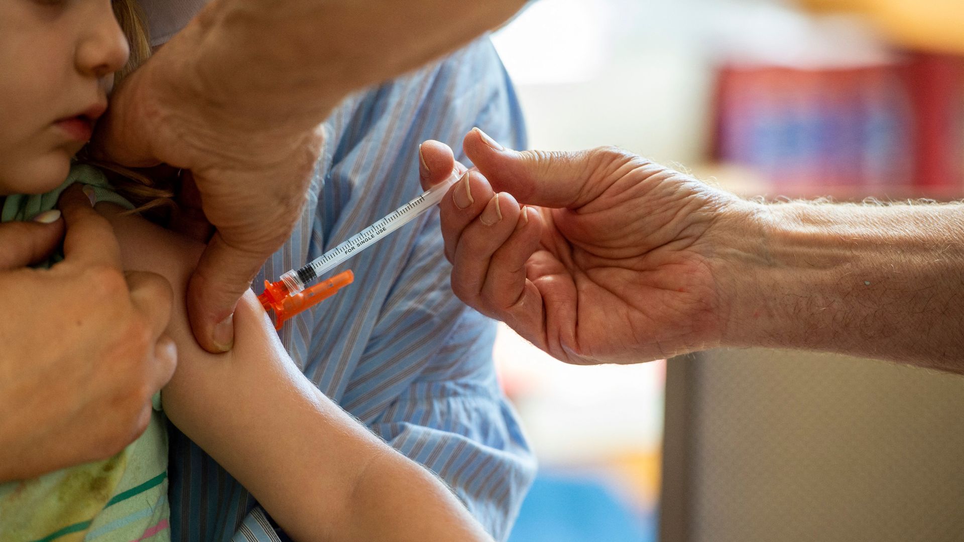A young child receives a Moderna Covid-19 shot