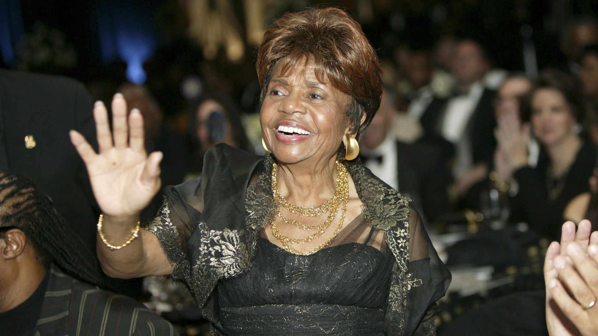 Edwards is pictured waving in a fancy gown
