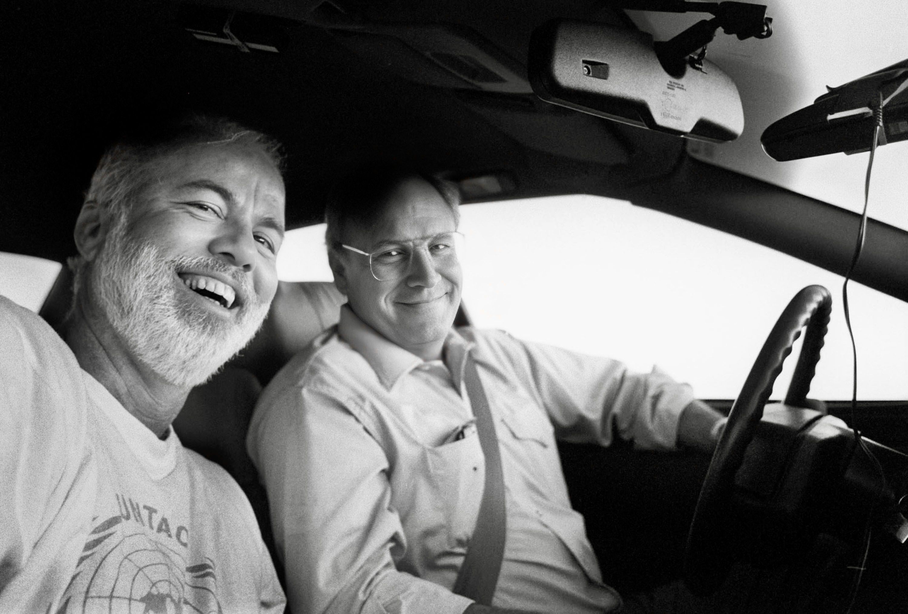 Black and white photo of photographer David Hume Kennerly and Dick Cheney sitting in a Cadillac in 1993.