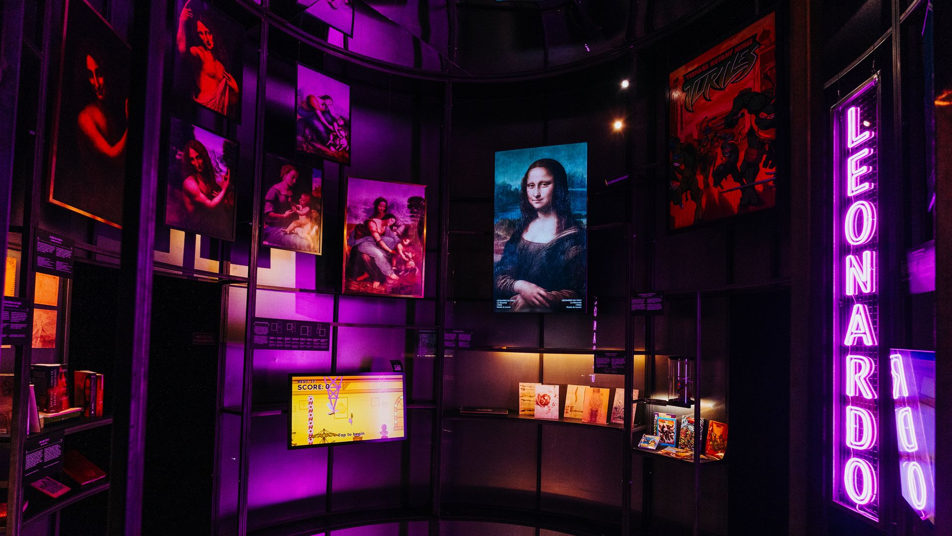Dark exhibit with purple lighting; paintings hang along curved walls, including a blue "Mona Lisa" center, plus a red poster and vertical purple neon sign on the right.
