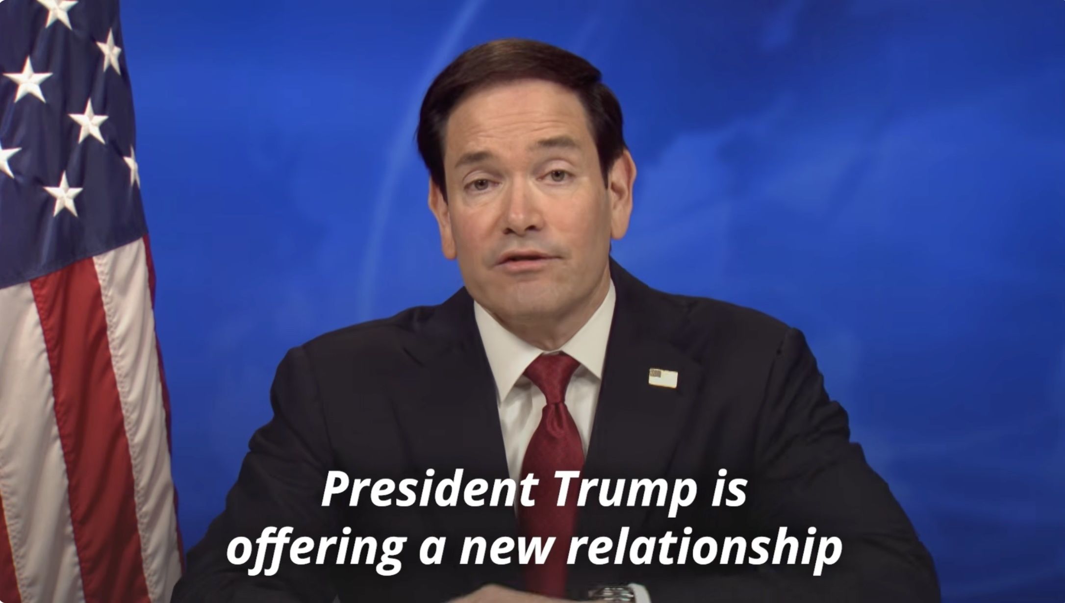 A screenshot from Marco Rubio's speech. A white caption reads "President Trump is offering a new relationship."