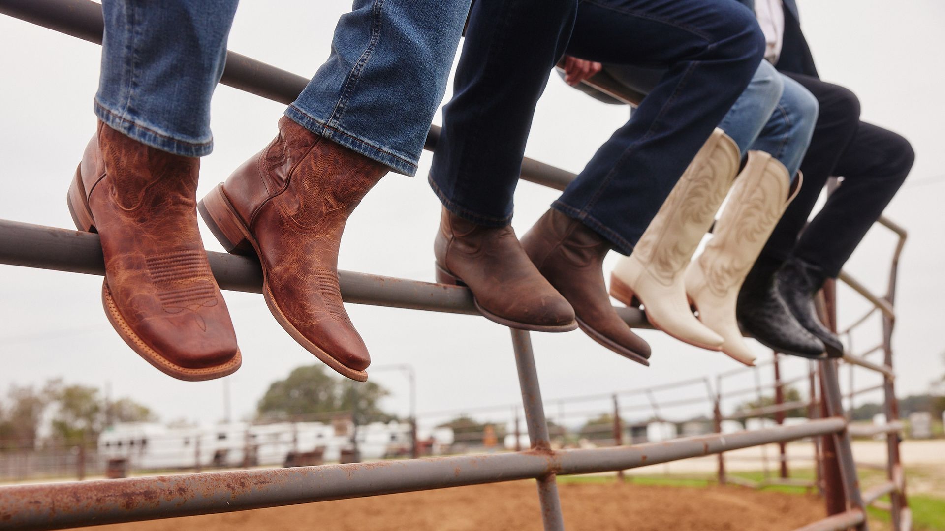 A photo of boots around a corral.