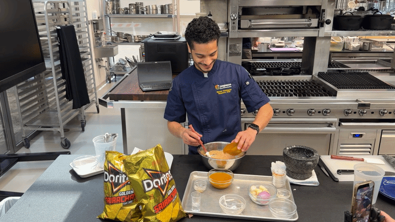 A chef pours yellow Sriracha into a mixing bowl