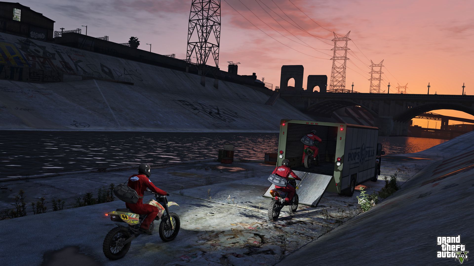 A screenshot of Grand Theft Auto 5 shows characters riding motorcycles into the back of a truck
