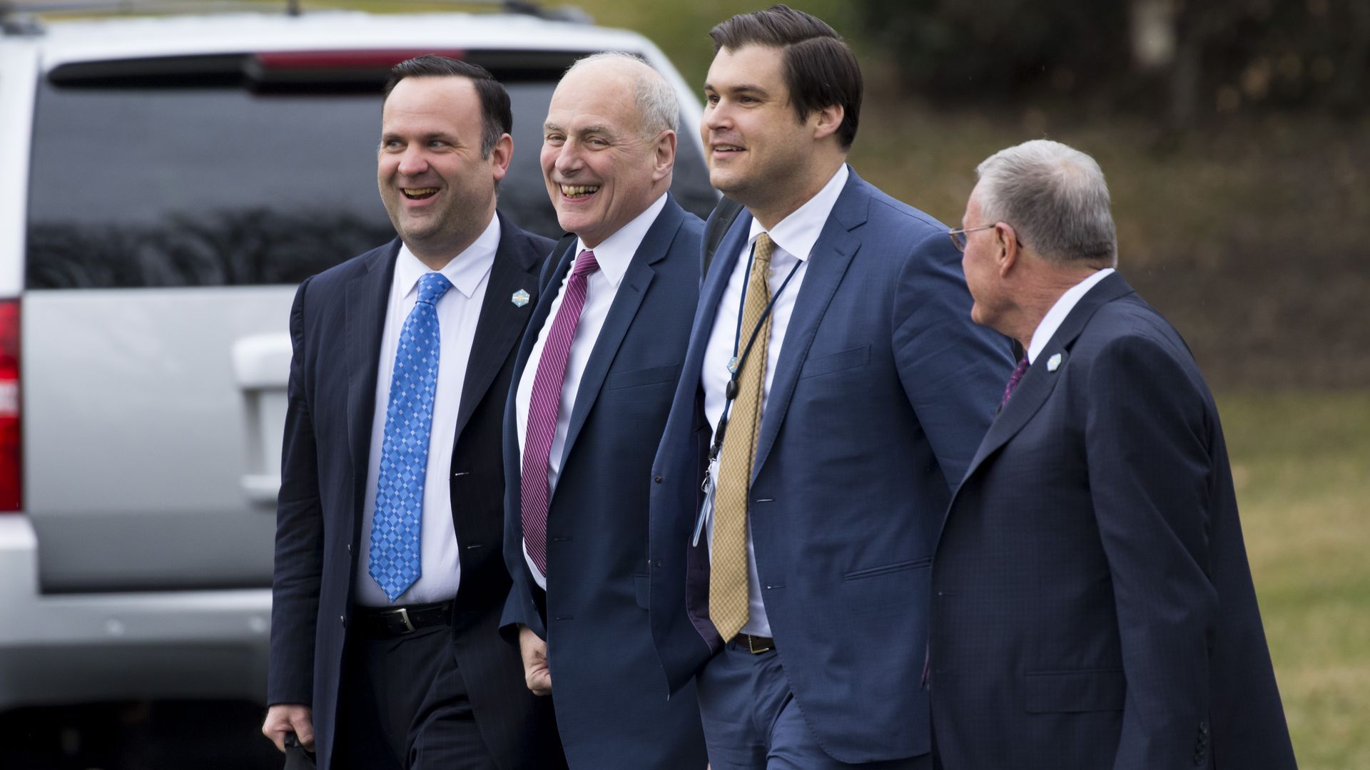 Trump aide John DeStefano walks across the White House grounds with other White House aides