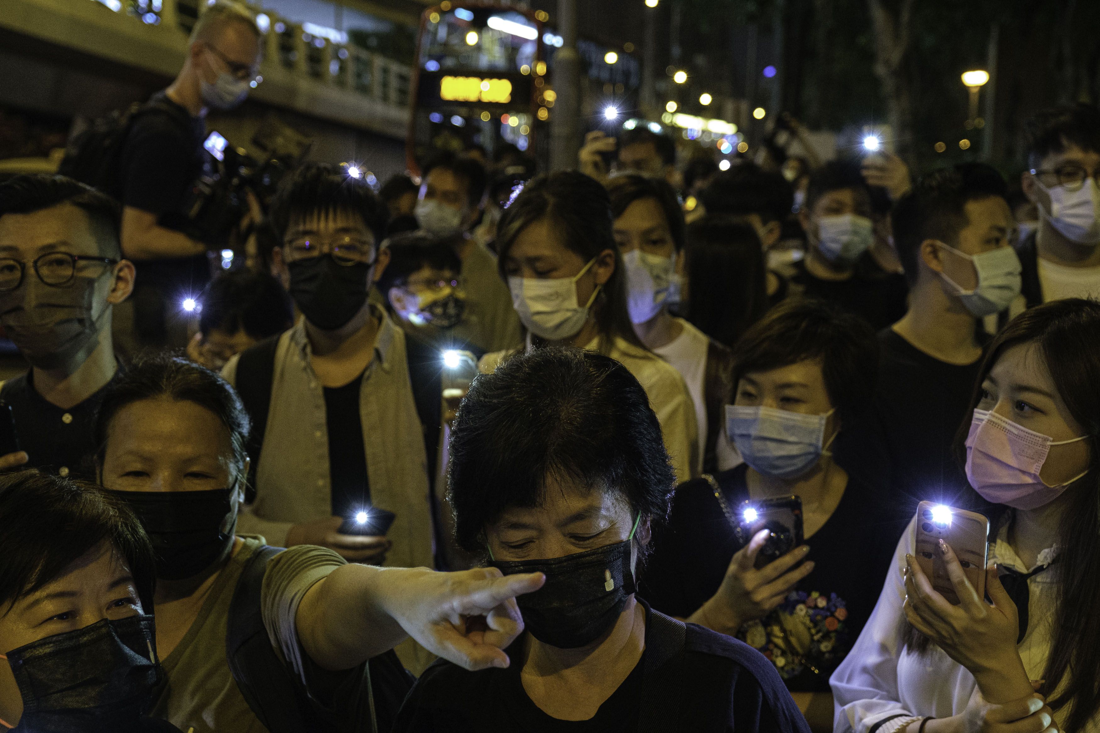 Photo of a crowd of Hong Kong people holding up mobile phones with their flashlight on