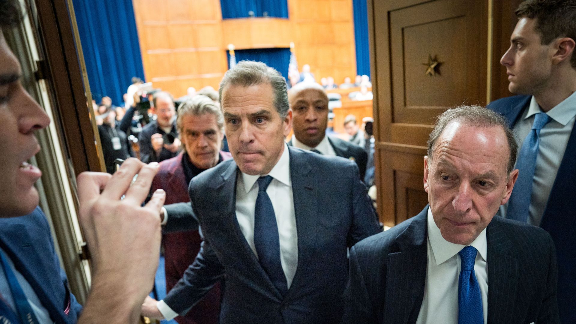 Hunter Biden, center, and attorney Abbe Lowell leave a House committee hearing