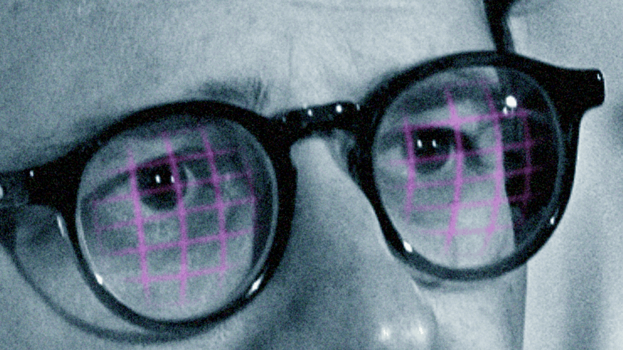 Animated photo illustration of a closeup of Dario Amodei's face. In the lenses of his glasses, a stock chart can be seen, with a trend line moving up and down from left to right.