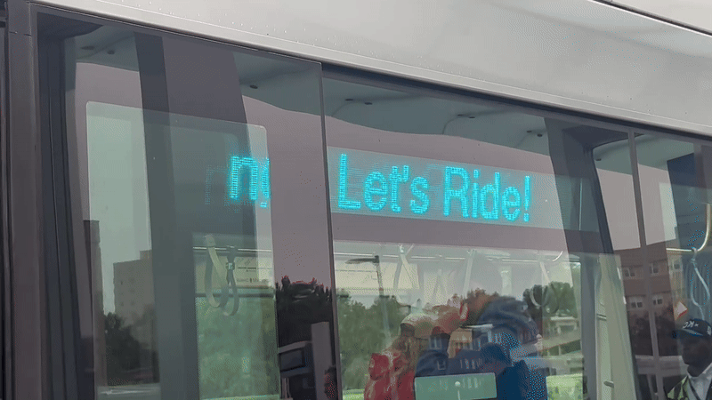 Gif on a loop forward and backward showing a KC Streetcar displaying a ticker sign reading "let's ride!"