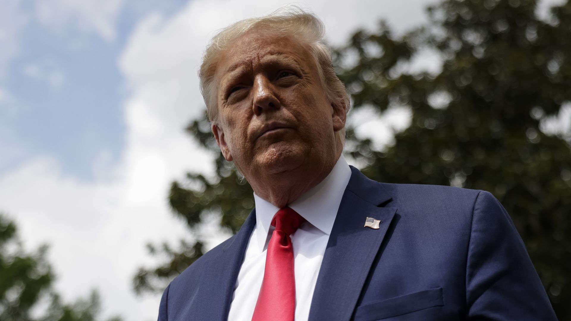 President Donald Trump stops to talk to reporters as he departs the White House.