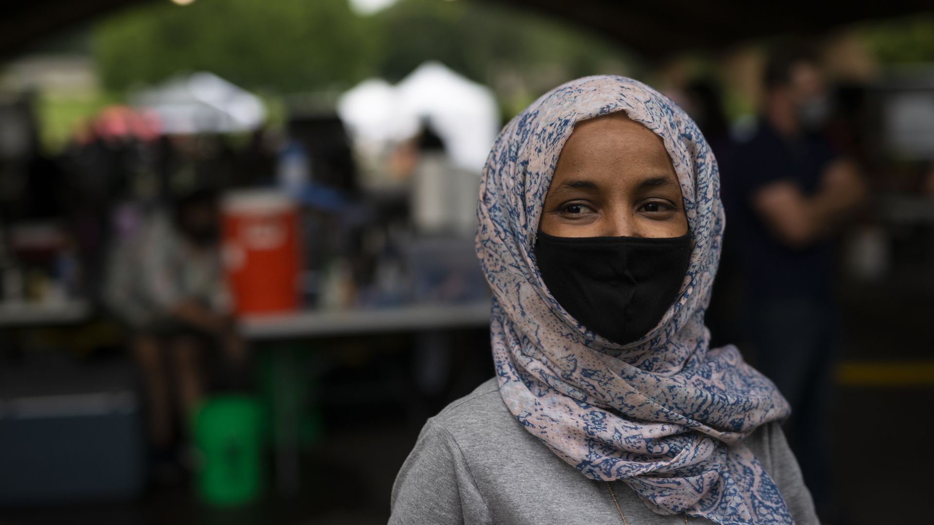 Rep. Ilhan Omar wears a face masks as she speaks to journalists ahead of the Minnesota primaries